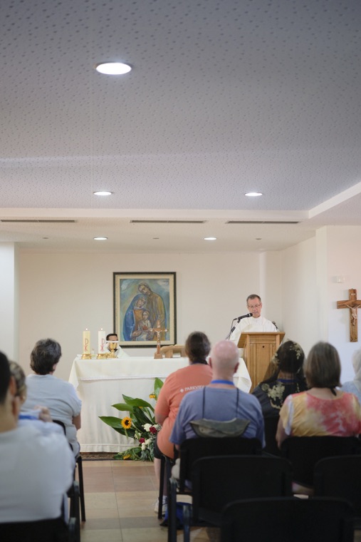 Mass in a chapel before an image of Our Lady of Guadalupe