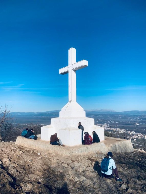 The white cross on Cross Mountain against a deep blue sky