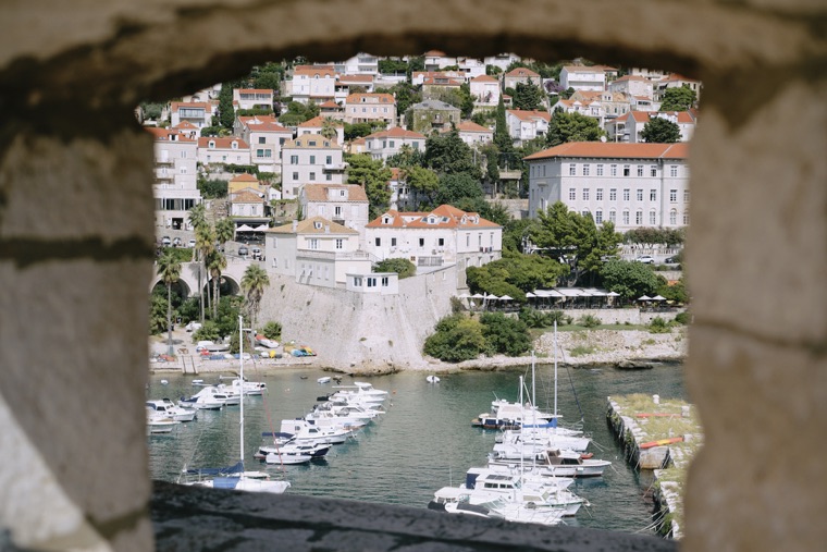 The old harbour framed by an opening in the wall