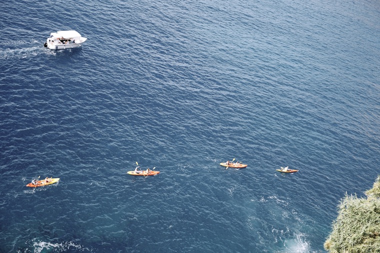 Kayaks on the deep blue sea below the walls