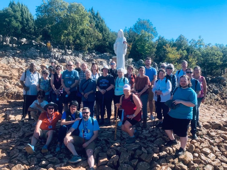 A Triumph group before the statue on Apparition Hill, 2022