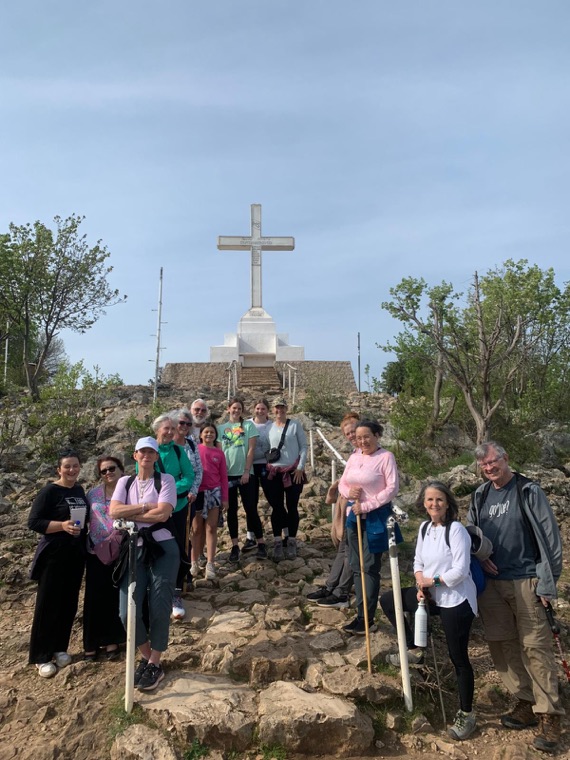 A Triumph group below the cross, 2024
