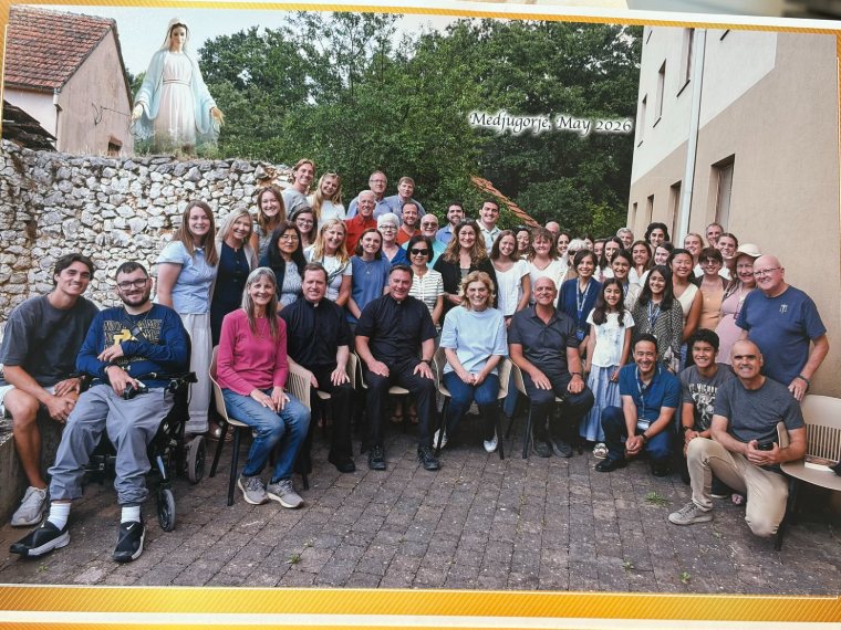 A large Triumph group below a statue of Our Lady, Medjugorje, May 2026