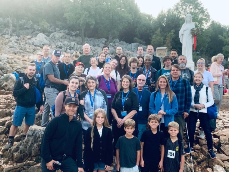A Triumph group before the statue on Apparition Hill