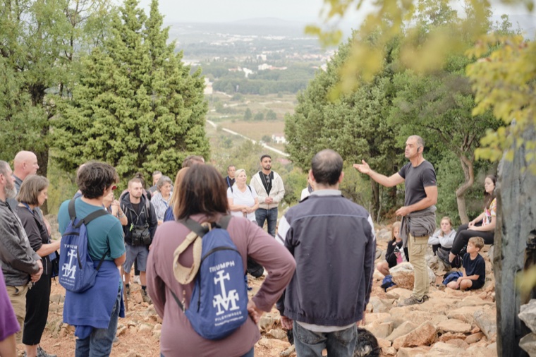 The group listening to a talk on the hillside