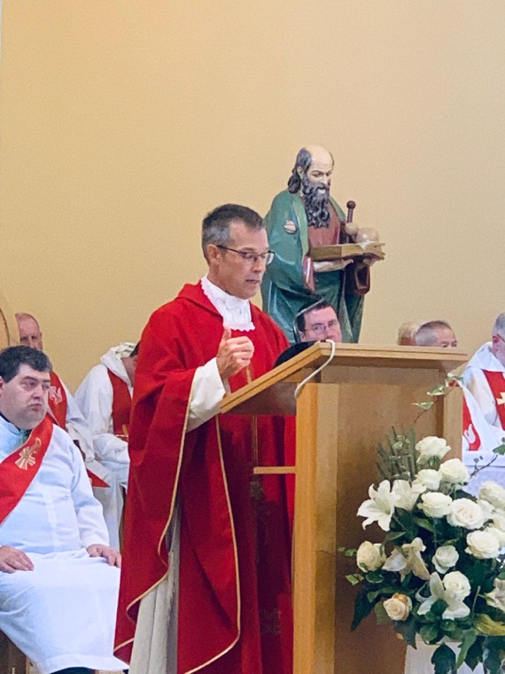 A priest preaching at Mass