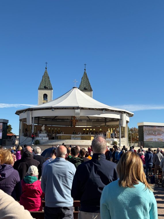 Pilgrims gathered at the outdoor altar behind St James