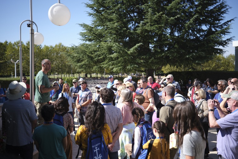 A crowd of pilgrims gathered outdoors