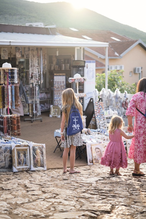 Children browsing a religious goods shop in the village