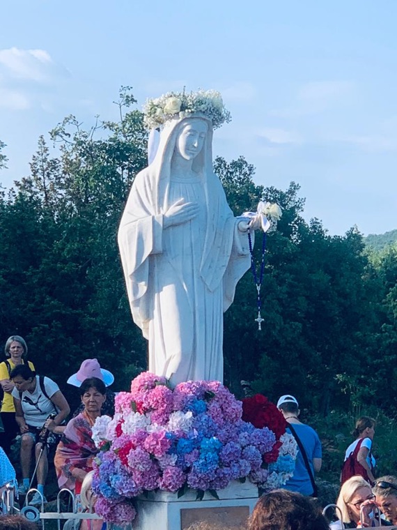 The statue of Our Lady crowned with flowers on the anniversary