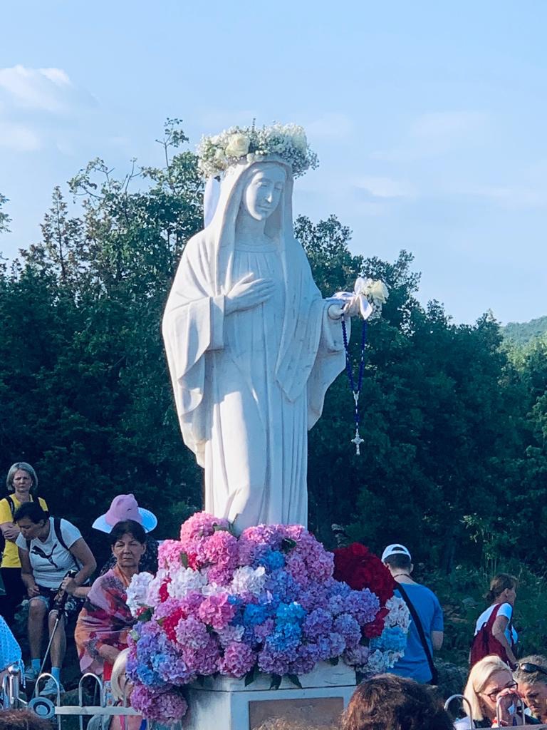 The statue of Our Lady on Apparition Hill, crowned with flowers