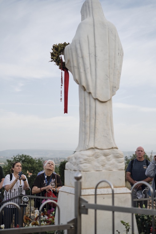 Pilgrims gazing up at the statue of Our Lady