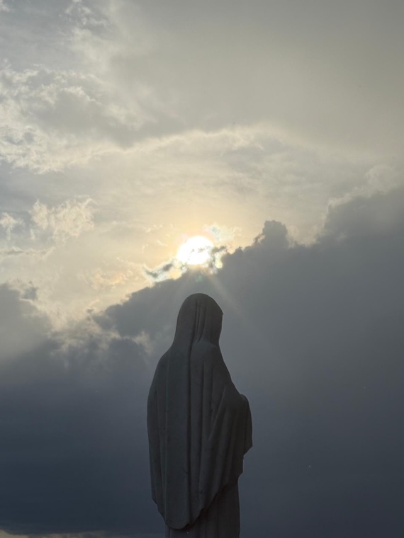 The statue of Our Lady before the evening sun