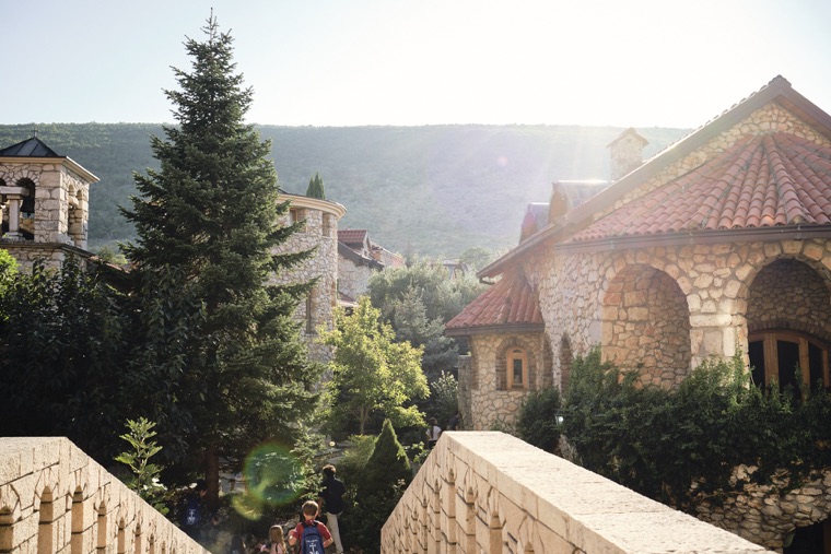 Stone buildings among the trees at sunset