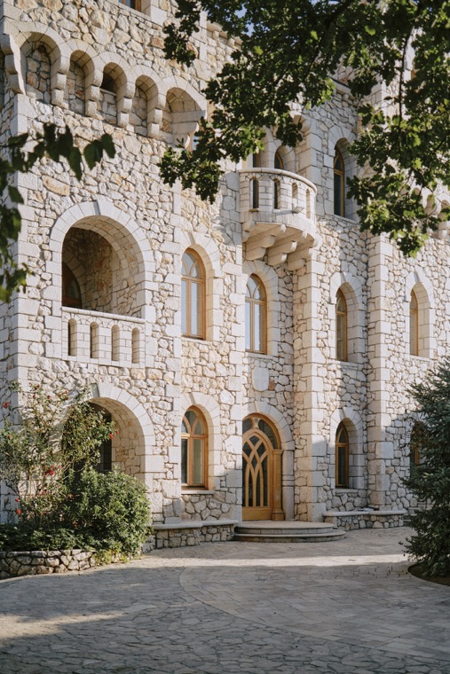 A stone facade with arched windows